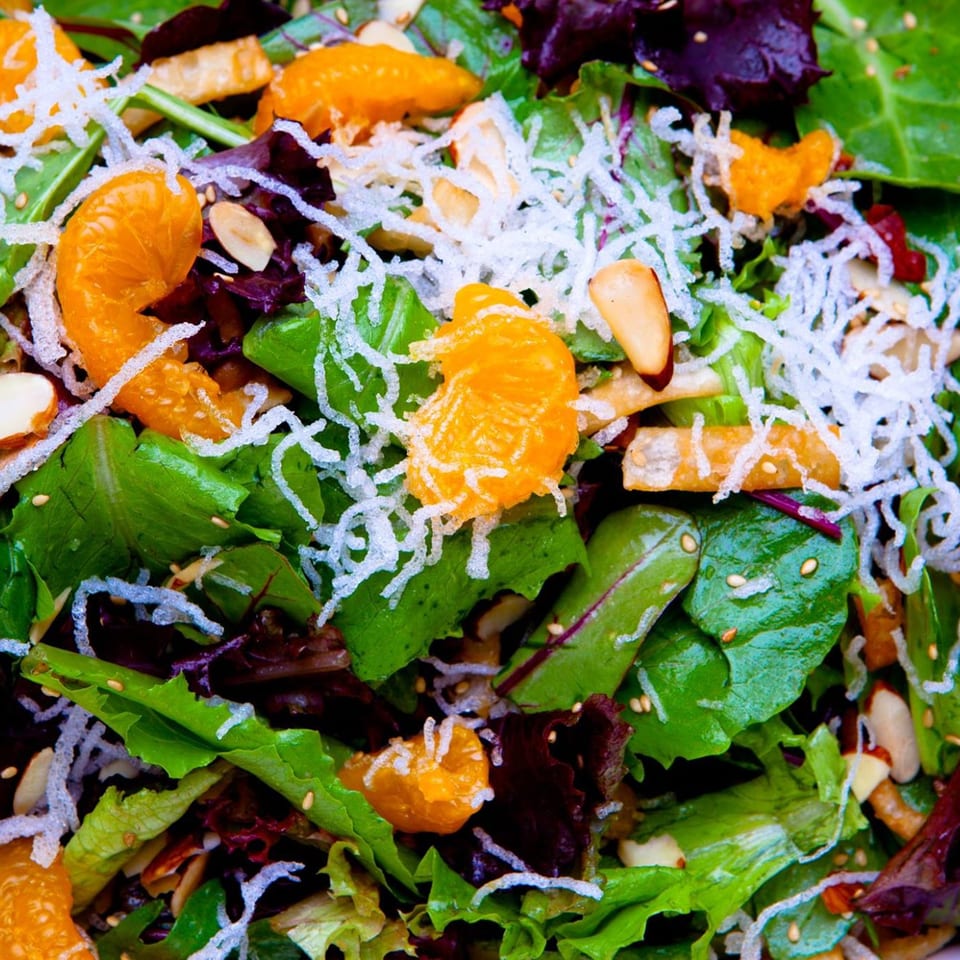 Sansai Japanese Grill's fresh green salad with mandarin oranges, crispy noodles, and sesame seeds.
