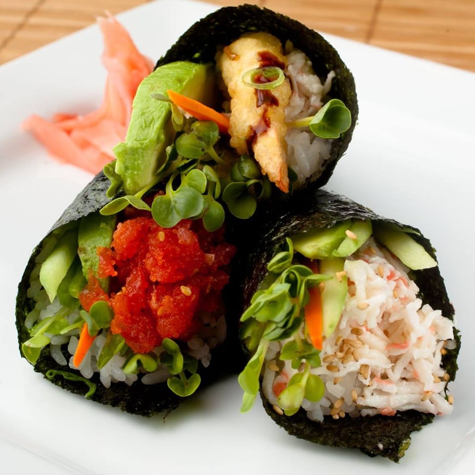 Three Sansai Japanese Grill hand rolls with various fillings, including crab, tuna, and tempura shrimp.
